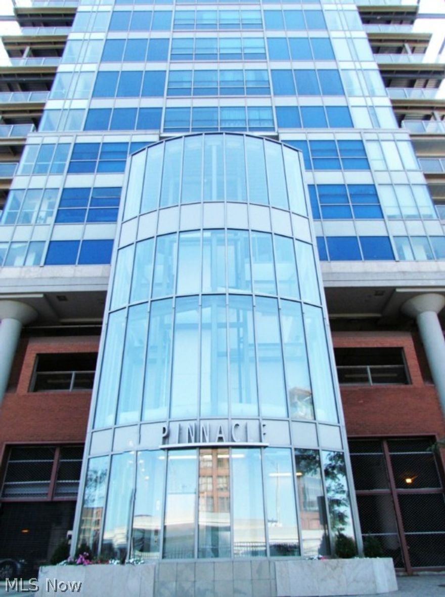 Pinnacle. Breathtaking lake views, from the moment you walk in the door. The whole western shoreline, the river and harbor views from an upper floor unit in downtown's premier condominium. High style contemporary finishing throughout. A stunning galley kitchen with a big breakfast bar, perfect for entertaining. Lots of detail, including bookshelves and a fireplace shared by the great room and the master bedroom. Large, well designed closets for ample storage and a wonderful master bath. Full Pinnacle amenities. Everything Downtown has to offer, right outside the door. An extra garage parking space is included. Full tax abatement through 2021.