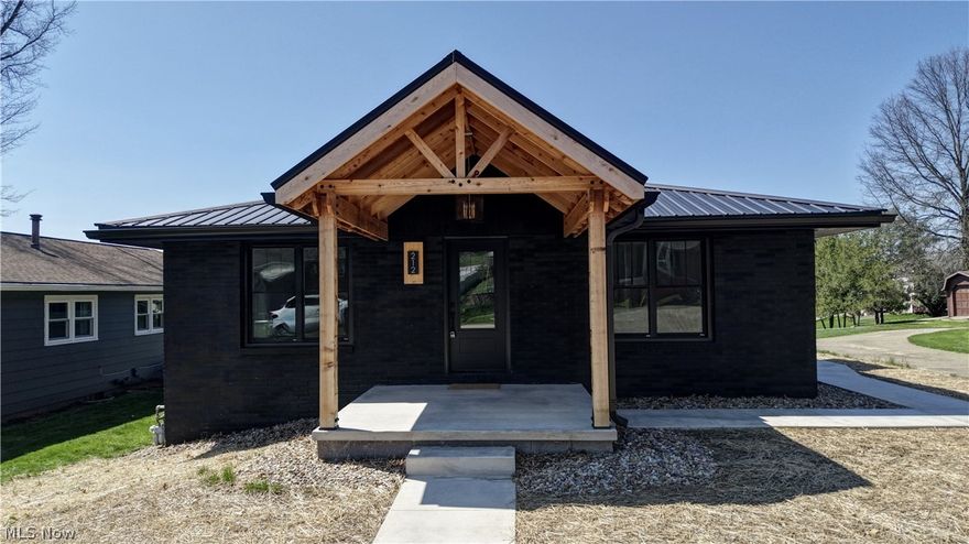 This home is a move in ready masterpiece! The deep tones create harmony and modern vibes that blanket the entire surface of this renovated exterior. The bold finish makes this home a stunner, complimented by the new modern wooden post and beam front porch.  Step into this 2025 meticulously renovated 3-bedroom, 3 ½ bath home where modern elegance meets functional living. The open-concept living space boasts bright, airy interior with premium vinyl plank flooring, leading to a stunning chef's kitchen featuring a center island, quartz countertops, Sage Green Shaker cabinets, brand new Forno quality appliances, wall-mounted pot filler and tile backsplash.  Relax in the luxurious primary suite with a spa-inspired bath complete with dual vanity, tiled shower and soaker tub. A second bedroom boast a private full bath with walk-in tiled shower.  This main floor includes a stunning half bath as well as a stylish Mudroom with seat and storage leading to the side entrance. The completely renovated walk out lower level is perfectly finished to compliment the first floor. Enjoy this large lifestyle-driven space with guest bedroom, gorgeous full bath with walk in shower, great room, storage space, laundry room and garage. This 2025 renovation includes, premium grade double pane windows, Pro Via exterior doors, solid wood interior doors, metal roof, garage door and opener, electrical panel, 3 panel solid wood interior doors. The cleaver new walkway from the front to the rear makes this home easily accessible. The Modern Refresh and complete renovation design achieved the inviting feeling of warm minimalism with open space, clean lines, and warm comforting colors. The effect is both classy and cozy. New Mailbox will be installed.