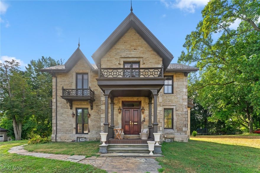 Step back in time without sacrificing modern luxury in this meticulously restored 1863 residence in the charming town of Salem, Ohio. Revived with respect for its history, the home features a restored exterior where original corbels & woodwork blend with a cleaned stone façade, new metal roof, & rebuilt porches, balconies, & decks—using as much original material as possible. Inside, the transformation continues. Though gutted, the home retains key historic elements. Solid oak floors run throughout, paired with custom Spanish cedar exterior & solid oak interior doors. A new HVAC system with three furnaces & A/C units ensures year-round comfort. The formal living room features an antique mantel from Hartville, original shutters, & a bold 3-tone paint scheme. The dining room showcases another antique mantel from Ravenna & original windows. The kitchen—a seller favorite—is both functional & elegant, with custom cabinetry & thoughtful details. Nearby, the main bath & back room(possible 1st floor bedroom), part of a later addition, features new plumbing, trim, & finishes. Modern upgrades include a wine room & new elevator, replacing the old servant staircase. A custom wine wall, trapdoor basement access, updated electrical, lighting, & a central vacuum system complete the home. Upstairs are two luxurious master suites. Featuring an antique mantel from West Virginia, an original mantel, walk-in closets, single/double vanities, clawfoot tubs, Chippendale mirrors, & private upper deck balcony access. Another bedroom includes an antique mantel from Pennsylvania & balcony access, while the cozy coffee area/library opens to a private upper deck. Just steps away are a shed & 4-car garage. This one-of-a-kind home blends history, craftsmanship, & thoughtful updates. Offering timeless charm & modern comfort in a peaceful small-town setting. A rare chance to own a piece of Salem’s past, beautifully reimagined for today.