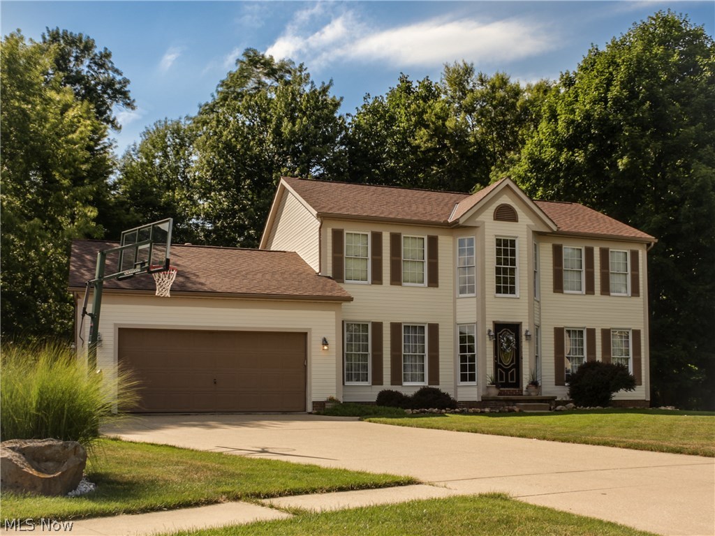 Rare opportunity to own a home in the highly sought after TALLMADGE HILLS PH III on a cul de sac with a walk out basement! Colonial home with 4 bedrooms, 3 full baths & half bath for total of 4 bathrooms! Large deck from rear of home overlooking the large serene, private rear yard since it is on a cul de sac! The lower level is fully finished with a media room, 2nd family room, full bar & 2nd kitchen, full bath with large shower and lower level has plenty of room for recreation tables then walk out thru lower level sliding glass doors to the rear patio & back yard! The main first floor has 2 Story Foyer flanked by the formal Living Room and Dining Room, Hall with Half Bath, huge Eat-In Kitchen with sliding glass doors to large rear deck, Family Room with fireplace and the 1st floor is rounded out by the Laundry Room. The second floor overlooks the foyer by way of a small loft that leads to the well proportioned Master Bedroom with Vaulted Ceiling and Large Master Bath & Walk In Closet!