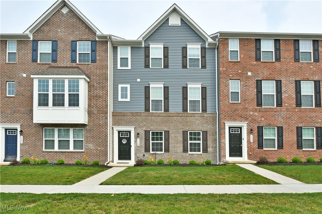 Make your townhouse dreams a reality as you explore the three stunning floors of this remarkable Akron offering! Putting you within minutes of the bustling downtown district and prominent neighborhoods alike, these modern homes provide the perfect solution while offering tons of style. Gorgeously appointed from top to bottom, the heavy use of glass work keeps the floorplans feeling open and airy. A rearward garage entry joins a bottom floor rec space that makes for a perfect lounge or workout room. Meanwhile, a unique split staircase bridges the front door and secondary garage entrance, rising towards the main floor. Here, the open layout wows with tall ceilings and hardwood style flooring. A gracious living room offsets the carpeted staircase as it reveals a charming half bath found around the corner. Whip up a delicious meal in the resounding kitchen with its long-stretched center island, topped in polished stone that pairs perfectly with the tiled backsplash and contrasting cabinetry. Formal dining looks on as a lattice lined door opens to find an exposed balcony overlook. The top floor is comprised of a closet lined hall with a gorgeous full bath located at the end. A trio of inviting bedrooms branch away, naturally lit with soft carpets. The oversized master bedroom includes a walk-in closet and a daring, full private bath with a tiered vanity and decadent glass and tile shod shower.