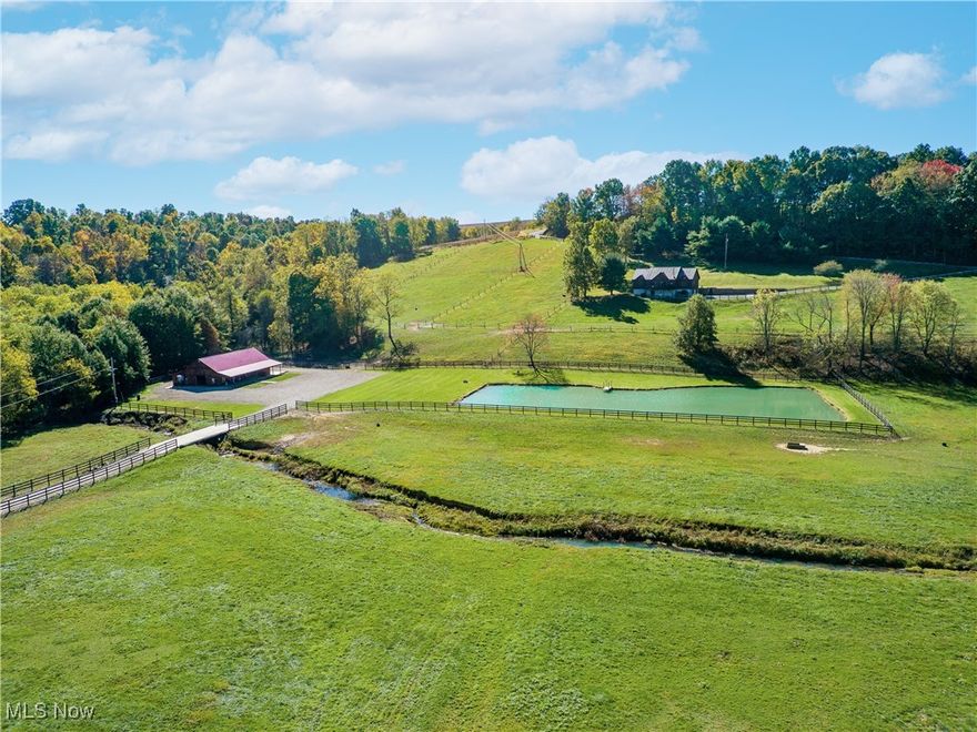 Here’s a unique opportunity to own a fully functioning farmette, featuring a 4-bedroom home, modern horse barn, machinery shed, stocked pond, and multiple pastures. The 2,233 sq. ft. home, built in 1997, offers a blend of country living and modern comfort. The log siding and large windows showcase fantastic valley views, while the open floor plan and vaulted ceilings create a bright, airy atmosphere. The main floor features 3 bedrooms, an eat-in kitchen with dark granite countertops, and a dining room that flows into the living room that has a wood-burning stove and patio doors that open to an expansive deck with panoramic views. Upstairs, you’ll find an additional bedroom and an open area that could be utilized for a home office. Built with a poured wall foundation, the walk-out basement houses extra storage and utilities, including an efficient forced-air geothermal furnace and central AC. The property is serviced by a private well and septic, and a two-car garage is located on the lower level. Additionally, the property offers a premier 39x67 horse barn, (Built in 2020) complete with a 10’ front porch and a 10x46 rear lean-to for additional storage. The barn features 8 box stalls, a feed room, wash bay, tack room, restroom, and office. The spacious loft allows for ample hay storage, with each stall equipped with its own hay chute. A ½ acre stocked pond adds to the property's appeal. Near the road, a 30x40 metal pole shed with power and its own well provides further utility. Added in 2020, extensive board fence surrounding the multiple pastures adds additional value.