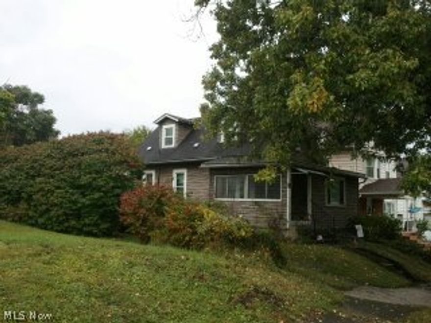 REDUCED! Cape Cod with second floor master bedroom, fully carpeted and 2 dormers. Formal Dining room and well designed kitchen with stove that stays. There are no neighbors all the way to the corner. Full basement, Full bath with claw foot tub, modern vanity, toilet and bathroom heater! So Toasty! Gas Furnace with central air, fairly new Hot Water Tank and updated electric 100 amp. service. .Adorable 1 car garage that is now used as a wonderful workshop and has a long carport extending from it to give you more covered parking or patio and entertaining space! Excellent Struthers schools! See this one today at this super low price!Lots of peace and quiet and the best price on a livable small home with extreme potential. This is a true one bedroom home now, nice size living room, big formal dining room, the kind where everyone can fit in and open to the kitchen with stove that stays and so does the furniture that you see! All the second floor is the master bedroom. large mud room on the f