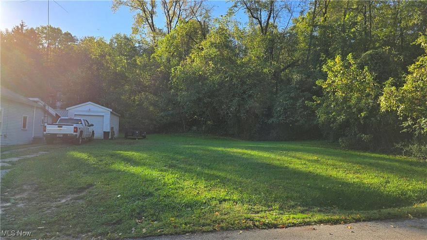 Looking for lots in all the wrong places?  Here's a little south side gem tucked in a quiet neighborhood!  Just under 1/2 acre, this lot already has a single car garage and driveway on it.  Utilities easily accessed, as the property used to have a house on it years ago.  The 3-parcel lot extends into the woods on the right side.  Wanting space for a storage building or a small home?  Consider this property for your needs!