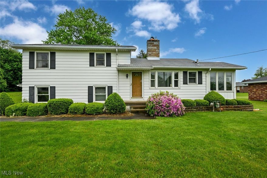 Take a step back to a time of true pride in ownership!  Things were made to last and these owners made sure they did!  This well maintained split level home sits on the front quarter of a stunning 2 acre lot!  Set back from the street, concrete driveway with additional gravel parking area, massive cleared back yard and woods at the back.  The main level features a combo kitchen & dining area.  Original kitchen, a huge picture window and an awesome double sided fireplace in a wall of sandstone blocks!  Don't miss the sunroom off of the kitchen too!  A cozy space to get away, relax and watch the wildlife.  Out the sliders to the small patio, you will find a permanent gas grill.  On the other side of the fireplace is the spacious formal living room.  Perfectly kept oiled oak floors, a custom wall mural and an amazing view of the back yard!  Up a short flight of stairs is one of the full bathrooms and all 3 bedrooms.  Each bedroom features beautiful hardwood floors and ceiling fans.  You don't need rose colored glasses to appreciate the pretty in pink original bathroom, in perfect condition!  The large family room is the perfect family hang out!  One door to the driveway, one to the garage and down the steps to the big basement.  Laundry room, storage, a great space to finish for more square footage and a second full bathroom with shower!  As you walk through the back yard you will see the little red pump house, perfect for watering the lawn and a garden.  Head back a little further to the outbuilding/third garage.  This is a great bonus storage spot or workshop.  Then you have remainder of the woods to the back of the property!  New water heater 2024, furnace and A/C in 2023, tapped into city water around 2020.  This is a phenomenal opportunity that you will not want want to miss!