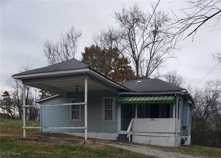 PRICE ADJUSTMENT:  Affordable cottage situated on 1.6 acres which faces Blennerhassett Heights Rd and crosses over Ohio River Rd in the back.  This property offers rare acreage in Parkersburg and is an excellent opportunity for a buyer who wants land, privacy and a chance to add value.  Home features two bedrooms, one bath, a covered front porch with great potential.  With some updates and TLC, this can become a charming full-time home, rental or flip.  Lot has room for an outbuilding, garage, garden and expansion.  Great for investors, contractors or anyone looking for a country feel, yet close to town.  Selling "AS IS".  MOTIVATED SELLER.