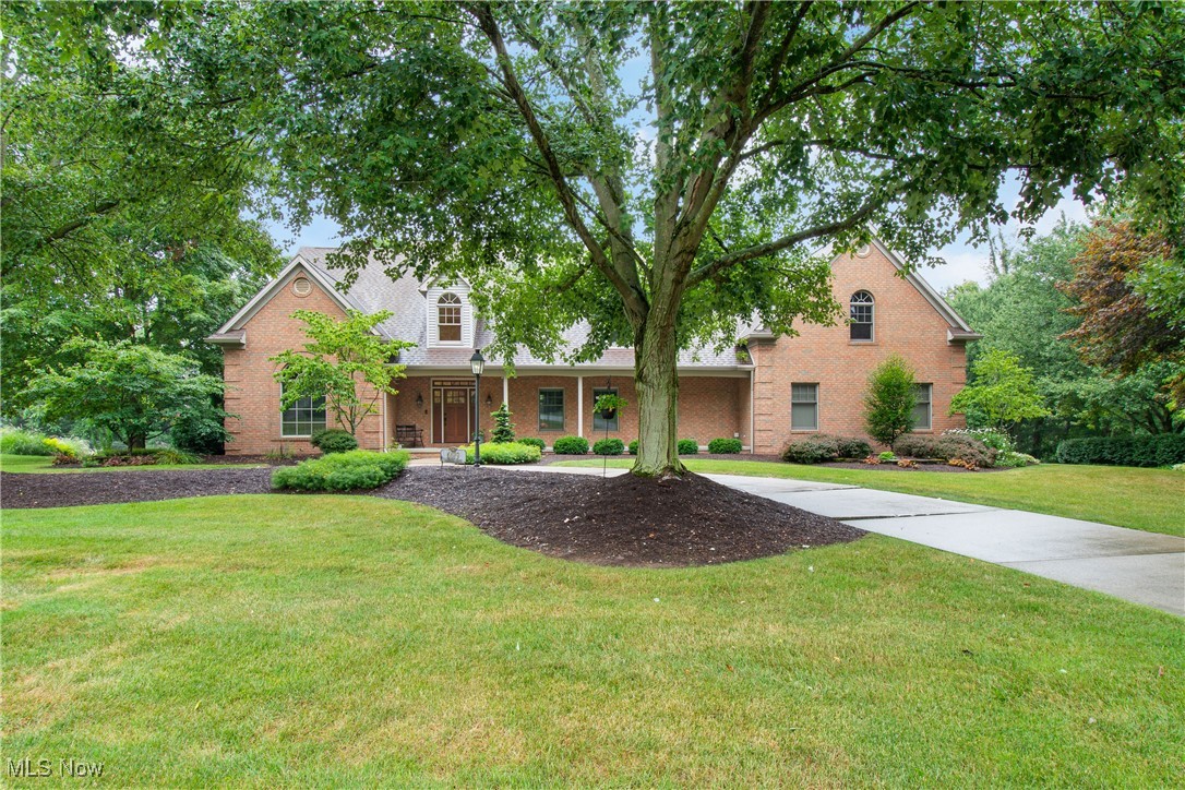 Prepare to be impressed by this exquisite all-brick estate in Jackson Township’s premier Windsor Green community! From the moment you arrive, you’re greeted by a sweeping circular driveway, a full-length front porch, and an oversized 3-car garage—all perfectly nestled on a beautifully landscaped lot. Inside, elegance and functionality meet at every turn. A grand 2-story foyer with an elegant curved staircase sets the tone, while the formal living room (perfect as a music room), spacious formal dining room with coffered ceilings and wainscoting, and a large office with beamed ceilings elevate the main level. The heart of the home is the beautifully remodeled kitchen, featuring rich custom cabinetry, granite countertops, stainless steel appliances, a large center island, and a seamless flow into the showstopping great room. The great room stuns with soaring arched windows, rich wood trim, and a custom fireplace with detailed millwork. An inviting 4-season sunroom with vaulted ceilings, a full brick accent wall, and oversized windows offers tranquil views and opens to a paver patio with a cedar pergola and 2021 Timber Tech Pro—complete with a wood-burning fireplace and built-in grill bump-out for unforgettable entertaining. The luxurious primary suite upstairs includes hardwood floors, a walk-in closet, cedar closet, and a spa-like bath with dual vanities, soaking tub, and separate shower. Two bedrooms share a Jack & Jill bath, and a fourth offers flexible space for another bedroom or guest room. The finished lower level expands your living area featuring a custom wet bar, expansive rec room, private gym, and a 600+ sq ft sound-dampened workshop. Even the 1st floor laundry room impresses with rich cabinetry, granite countertops. Highlights include: whole-house security system, sprinkler system, roof (2017), windows (2017), front door (2017), dishwasher (2021), microwave/oven (2021), gutters (2018), furnace/AC (2013) Exceptional property!
