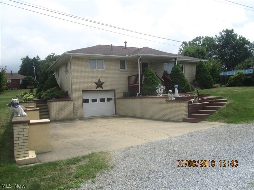 Classic brick home that has had superior care and shows it.  Hardwood throughout except kitchen.  Living room has recent carpet over.  9' x 25' carpeted sunroom across the entire rear of the home.  Third bedroom is set up with 2 doors so that it can be used as a dining room or bedroom - whichever is needed. 
   Basement is carpeted and used for additional sitting room.  Included is a  jetted handicap type tub with a walk in hinged door. Garden shed.
