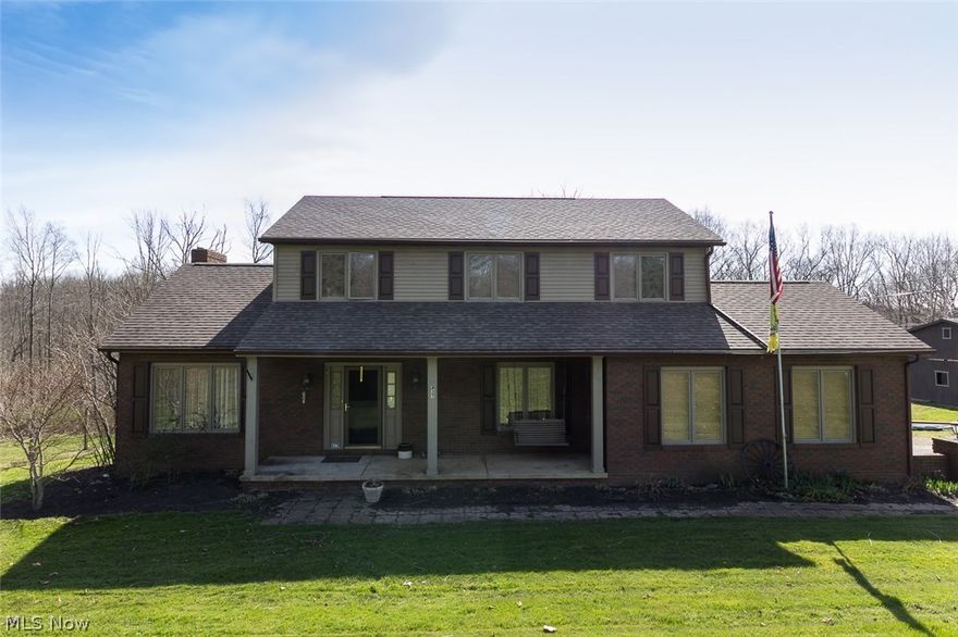 Tucked up against the Cuyahoga Valley National Park are two acres of natural perfection adorned by this exquisite colonial home.  With plentiful updates throughout including gleaming hardwood, crisp ceramic tile and elegant in-laid crown moldings you will fall in love at first sight.  There is an open feel to the first floor as the eat-in kitchen with maple cabinets and Corian style counter tops flows into the spacious living room with wood-burning fireplace and sliding door to the raised deck.  Upstairs you will find the owner's suite as well as two more sizable bedrooms, all with ample closets.  Each bathroom is well-appointed and fresh.  The owner's bath features double-sinks, recessed lighting and a soaker tub with shower.  The finished walk-out basement can be enjoyed as a family room with the option for additional guest space or office in the bonus room.  And the five-stall barn and fenced meadow allow you to expand your love of nature onto your own property as animals are permit