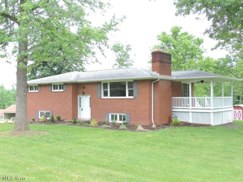 Stately brick Bi-level in the SANDY VALLEY school district. New kitchen cabinetry with Corian countertops and new stainless appliances. Whole house freshly painted with neutral colors and added new carpeting with some ceramic tile floors. New interior and exterior doors and 90% new windows throughout the home. Main bath has double skink vanity. Bedrooms have spacious closets. Dining area has sliding glass door leading to a covered composite deck with recessed lighting and an outdoor ceiling fan. Great place for an outdoor party. Family room has a fireplace with a wood stove insert. Lot of natural light throughout the home. Open staircase to the lower level. There is a 9X17 room that has a walkout exterior door to the back yard, this could be an office for an in-home business. New concrete drive to the garage from the street. Quiet location on a cul-de-sac. Just minutes to Canton or Dover. There is really not a thing to do here but move your family in and enjoy the 1+ acre lot.