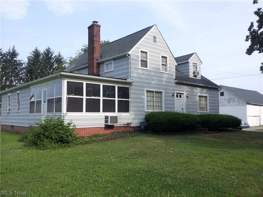 Located 1.6 Miles off I 71 at the corner of Car Quest Blvd. and W. 130th Street (INDUSTRIAL PARK) This Large home has great character on 3 acres of INDUSTRIAL LAND with 691 feet of road frontage***All utilities are available including a fiber optic communications line***This Home/Office has an in-law suite, 4 bedrooms, 3 full bathrooms, basement and hot water heat***The 4 additional buildings provide plenty of additional storage for up to 7 cars inside the 28' x 50' BARN with electric***Perfect for Home/ Business**Mini-farm**Industrial Development and more.  Call for an appointment!