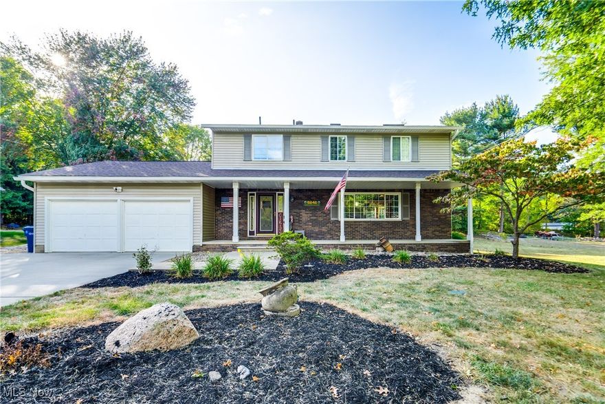 We're so excited to bring you this beautiful home! Welcome to this beautifully updated four-bedroom, 2.5-bath colonial. Step through the front door into the inviting entryway, where to the right is the spacious living room, which greets you with a large picture window that fills the space with natural light. The living room flows seamlessly into the dining room, which provides easy access to the back deck—perfect for outdoor dining and entertaining. The kitchen is a chef's dream, featuring gorgeous countertops, ample cabinet space, and newer appliances. Adjacent to the kitchen, a cozy dinette area offers additional dining options. The family room comes complete with built-ins and a fireplace. Completing the first floor is the newly updated half bath, completed in September 2024. Upstairs, you'll find four generously sized bedrooms, including a master suite with its own private full bath. The hall full bath is equally impressive, with a vanity boasting double sinks and stunning countertops. The exterior of the home is just as remarkable. A large paved driveway leads to a two-car attached garage, while the front porch offers a charming spot to enjoy your morning coffee. The backyard is an outdoor oasis featuring a nicely sized deck and a patio with a firepit area—beautifully redone in 2022. Plus, the home is minutes away from Manchester High School, Nimisila Trail, and shopping. Don't miss your chance to see this beautiful home; schedule your showing today! Other updates include High-efficiency Carrier HVAC in June 2024, a water heater in August 2024, an Outdoor firepit/patio area with power/lights done in 2022, Samsung matching appliances in 2021, and a yard drainage system around the patio done in 2022.