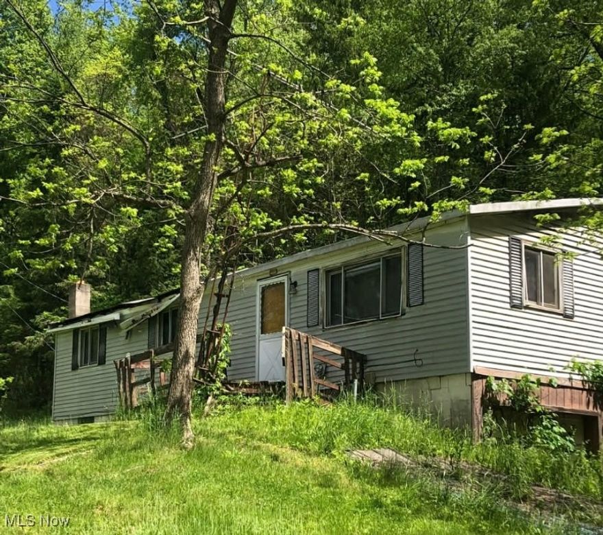 Secluded 22-acre wooded property offering privacy, natural surroundings, and multiple rural-use possibilities. Existing home is vacant, uninhabitable, and should be considered a tear-down. Property is being sold strictly AS-IS; no repairs or improvements will be made by seller. Electric is already run to the property, with access to sewer and septic available. Ideal for those seeking a remote setting for a new homestead, hunting land, timber use, or private recreational retreat. Buyer to verify all property details, utilities, and intended use.