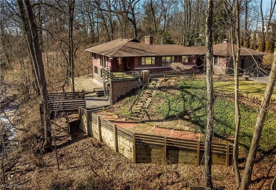 Back on the market following an extensive interior renovation, this 3300 sq ft Frank Lloyd Wright inspired ranch is situated on the edge of a gorgeous ravine in Silver Lake Estates offering breathtaking views of nature. Lovingly maintained by the same family for many years who also carefully preserved many of its charming vintage features creating an atmosphere that is warm & inviting throughout. Beautiful natural woodwork trim & recently refinished hardwood floors throughout.Foyer entry leads into the expansive formal living rm combined with the formal dining rm creating an open &  spacious feeling. This area has a woodburning fireplace & floor to ceiling windows brightening the rooms w/natural light and exposing the beautiful ravine view.Updated kitchen w/ceramic floors, stainless appliances & beautiful black granite counters. Cozy den has knotty pine paneling,beamed ceilings & a peg wood floor. Two spacious bedrooms on main level, updated full bath,1/2 bath,and first floor laundry.T