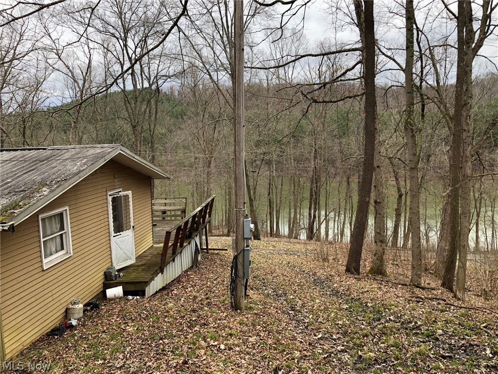 Lake front cabin on Huff Bay at Clendening Lake. Enjoy life on the lake for a low upfront cost. Home needs a little TLC but what a better location on a great fishing lake. Large front deck overlooking the water with open concept living room and kitchen, 2 bedrooms and 1 bath ready for your personal touch on privately owned land.