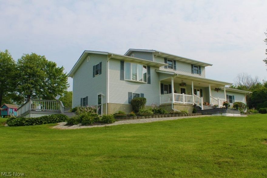 8161 Hazel Dell Road.  Friends and Family will WANT to visit you on this 5-Acre Rural Retreat in Amish Country! Set up for outdoor entertaining with two decks, hot tub, fire ring, volleyball, covered rocking chair porch with breathtaking views of rural countryside, and regular clip-clop of buggies going by. Everyone will have their own zones in this spacious 5-level split, that includes 4 BR’s, 2.5 Baths, Updated Corian Kitchen, Cozy Fireplace, Large walkout Family Room and more. Like FREE HEAT? All it takes is a little elbow grease and the outdoor wood boiler unit heats house and 24x30 detached workshop/man cave, and heats your water for guilt free long hot showers! Propane is your other option. Solid 6-panel doors, Andersen Windows and updated fan lights throughout. 200 Amp service with generator hookup (generator not included). There’s even a safe room/storm room in the lowest level. This is a wonderful family home with great neighbors. Located a mile east of intersection of US62 &