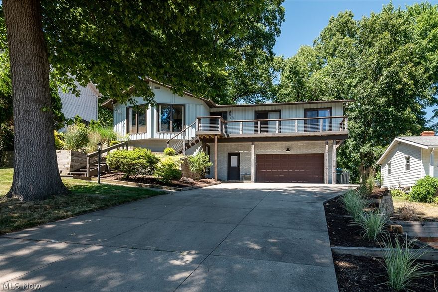 If you are looking for lake living, look no further.  This place will not disappoint as its in mint condition and walking distance to Portage Lakes.  This property includes a dock with an amazing treed backyard, an enclosed porch and multi-tier decks.  Inside has so many upgrades as it has been updated from top to bottom.  This home features an open floor plan, stainless steel appliances in the bright white kitchen and beautiful flooring throughout the home.