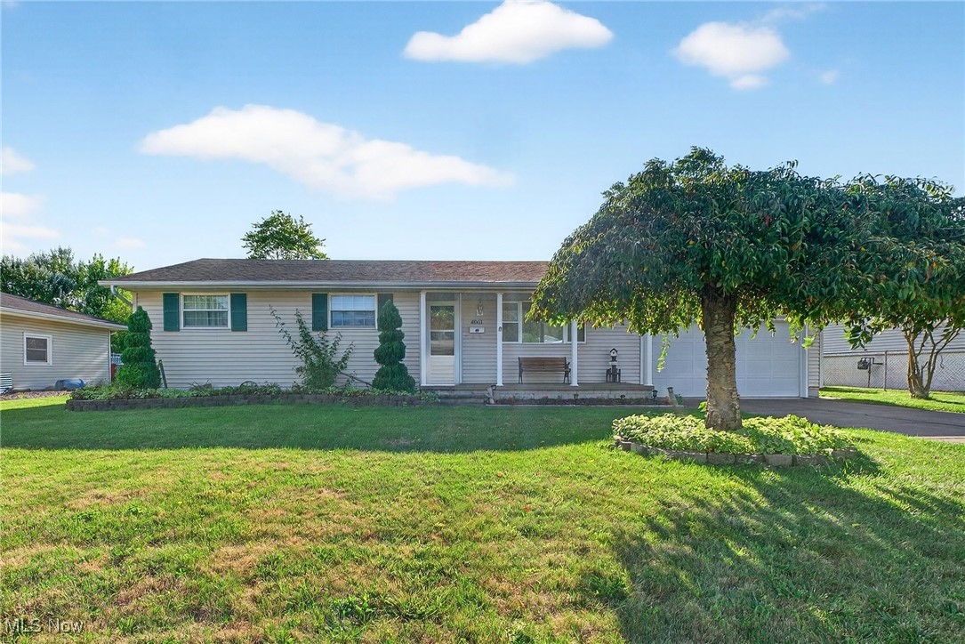 Welcome to 4061 Kenyon Avenue! This well-maintained ranch sits in a convenient Lorain location—near local parks, quick freeway access, tons of shopping and restaurants and just minutes from Lake Erie. Yet Kenyon is a quiet residential neighborhood and the backyard is your private oasis. When you enter the home you are greeted by a custom, handmade entry door curated by the homeowner. The bright living room is anchored by a large picture window. The eat-in kitchen offers stainless steel appliances, ample cabinetry, a mobile island for functionality, and a clear view into the inviting three-season room—perfect for relaxing or hosting. Down the hall are three comfortable bedrooms and a full bath. The partially finished basement expands your living space with a rec room, laundry area, and ample dedicated storage. There is plenty of room to create your own vision downstairs. Outdoors, enjoy a fenced backyard with a paver patio, easy-care landscaping, and plenty of green space for play or gardening. A great blend of comfort, function, and location!