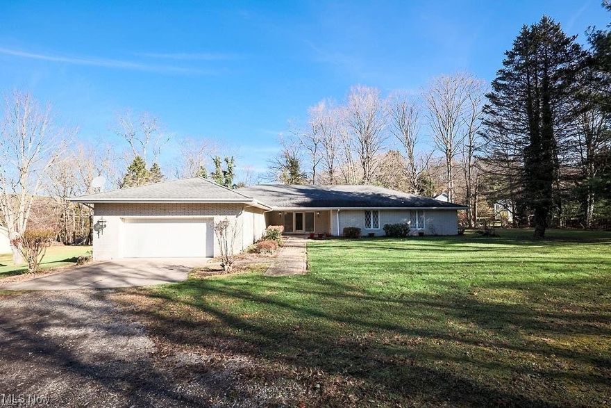 This absolutely gorgeous white brick ranch home offers luxury living with an overabundance of closet and storage space. The rooms are all spacious and inviting. All you need to do is paint and decorate to your taste and move in! Enjoy entertainment both inside and out with plenty of room for the extended family and friends. Go outside and enjoy the large flat nearly 3/4s of an acre lot on a dead end street. The property connects to many acres of wooded WV game lands. Live the country life and be within 15 minutes of town and less than an hour to Pittsburgh PA.  The downstairs is mostly finished with all electric and water in place as well as sheet rocked walls and recessed lighting. The downstairs already has the layout in place for a huge family room complete with a wood burner and two additional possible bedrooms as well as the 3 bath and LOTS of storage. The two car garage offers access to a huge shop and utility area as well as upstairs kitchen access. Total one story living is ava