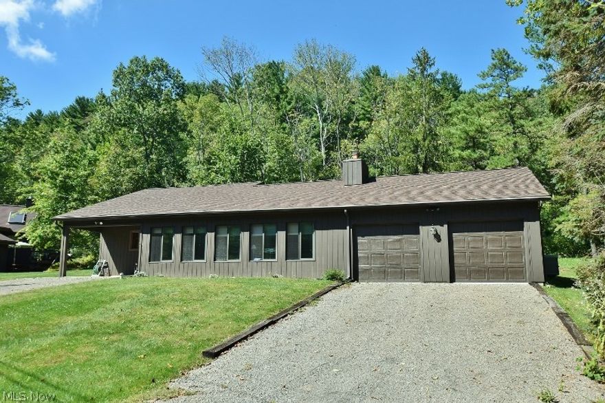 Time to start enjoying the good life of lake living. Well maintained & affordable 2nd row Atwood Lake ranch home in the popular North Shore community. Easy to maintain lightly landscaped lot for this 2 bedroom/ 1.5 bath lake home suitable for year round use or as a second home. A quality private dock is included and an easy walk from the home located close to one of the 3 community beaches available to the residents and guests of the community. A beautiful enclosed porch showcases the beautiful setting & offers seasonal lake views to enjoy. Open format living room & kitchen. Beautiful wood burning fireplace. Timeless knotty pine tongue and groove throughout most of the home. The kitchen has been updated with beautiful pecan cabinetry with pull out drawers. All appliances will remain with the home including the washer and dryer as well as a freezer. The large common bath features an oversized shower and separate tub. In additiona there is a half bath in the laundry/ utility room. The la