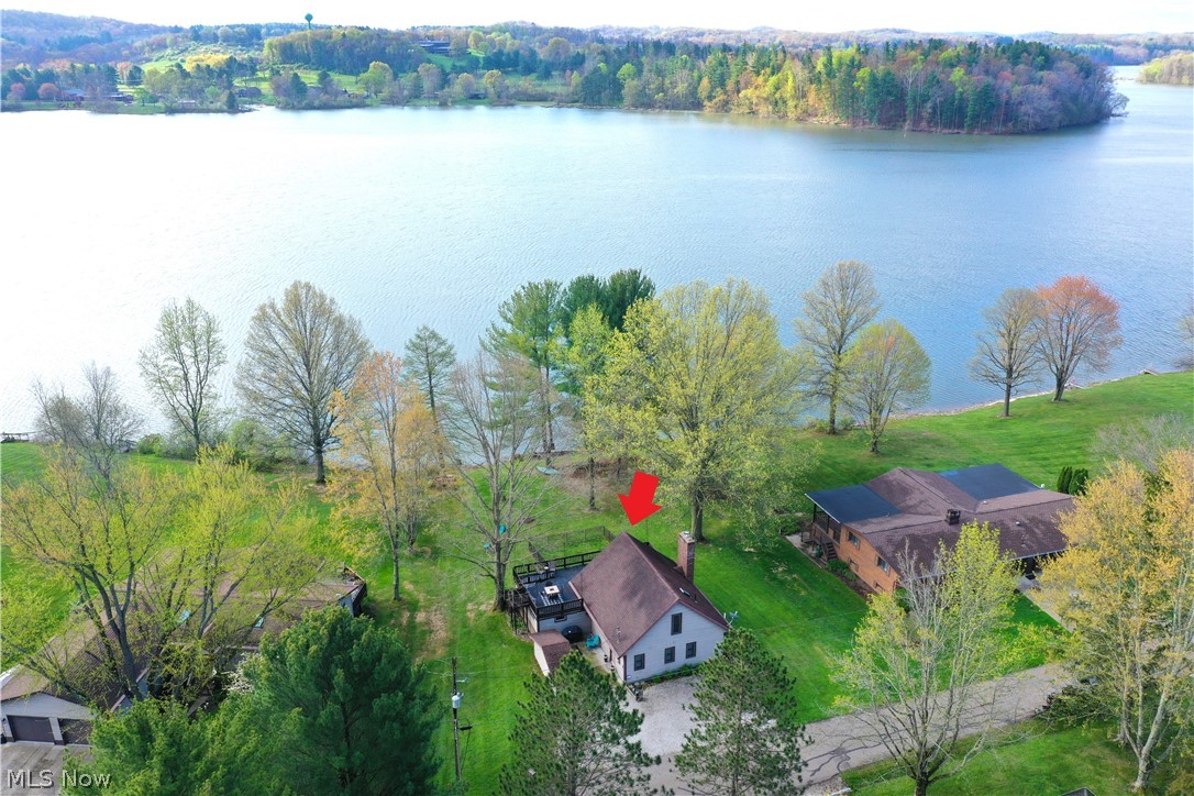 1271 Arrowhead Dr SW, Dellroy, Ohio 44620 is a beautiful lake home on Atwood Lake of the Muskingum Watershed Conservancy District, can you say location, Location, LOCATION and lake, Lake, LAKE! 25 minutes Northeast of New Philadelphia & 29 minutes South of Canton, this Lakefront home has 3 bedroom between both levels and 2 full bathrooms, one on each level. The Lakehouse sits on a lush large lot with a fenced in lakeside area on the rear of the home, perfect for keeping an eye on the kids & pets as well as entertaining. Gorgeous lake views of the sun across the lake with a floating dock , plenty of yard for parties, grilling, fun in the sun or relaxing under the large tree near the edge of the lake. Atwood Lake has two Marinas on the East end of the Lake as well as the West end, both with restaurants, shops, gas for all your lake toys, fishing and boat rentals of several types, including pontoon boats, sail boats, paddleboards, kayaks, paddle bikes, and more! When you walk into the home, your eyes are drawn to the lake view from the entire lakeside of the home which sets up from the lake for wonderful views and the all important dry home with award winning, publish ready photos of the million dollar views! Bring your family and move right in or have as a second home for the weekend lake life! There is the potential to purchase chattel / furniture as well. There is plenty of seating options between the Living Room, Family Room, outdoor lake side main floor outdoor Patio and the 2nd floor Terrace outdoor entertaining area with full set of exterior steps to the ground level. This home will not last so make your appointment today! Call your favorite real estate professional or come to our open houses. There is a fee to write the new lease for the Buyer and both the Seller and Buyer will pay MWCD a fee of $250 for that. The lease and homes taxes will be prorated through the date of the closing. Comes with a 1 year warranty for your peace of mind.