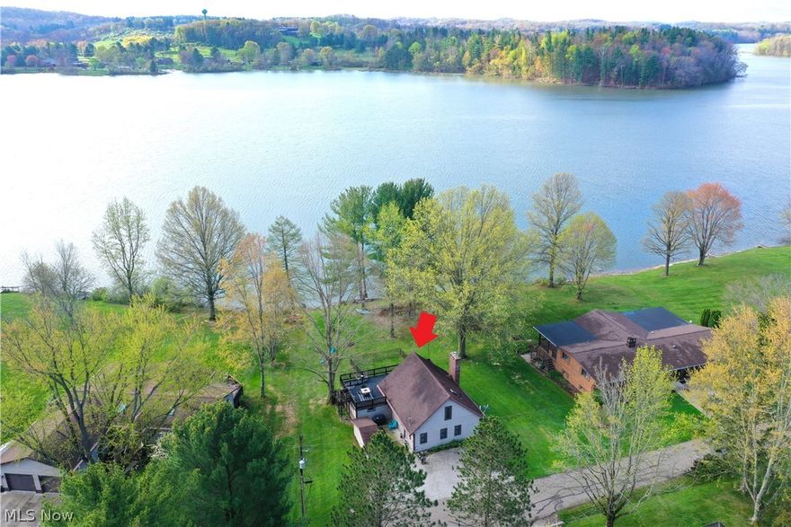 1271 Arrowhead Dr SW, Dellroy, Ohio 44620 is a beautiful lake home on Atwood Lake of the Muskingum Watershed Conservancy District, can you say location, Location, LOCATION and lake, Lake, LAKE! 25 minutes Northeast of New Philadelphia & 29 minutes South of Canton, this Lakefront home has 3 bedroom between both levels and 2 full bathrooms, one on each level. The Lakehouse sits on a lush large lot with a fenced in lakeside area on the rear of the home, perfect for keeping an eye on the kids & pets as well as entertaining. Gorgeous lake views of the sun across the lake with a floating dock , plenty of yard for parties, grilling, fun in the sun or relaxing under the large tree near the edge of the lake. Atwood Lake has two Marinas on the East end of the Lake as well as the West end, both with restaurants, shops, gas for all your lake toys, fishing and boat rentals of several types, including pontoon boats, sail boats, paddleboards, kayaks, paddle bikes, and more! When you walk into the home, your eyes are drawn to the lake view from the entire lakeside of the home which sets up from the lake for wonderful views and the all important dry home with award winning, publish ready photos of the million dollar views! Bring your family and move right in or have as a second home for the weekend lake life! There is the potential to purchase chattel / furniture as well. There is plenty of seating options between the Living Room, Family Room, outdoor lake side main floor outdoor Patio and the 2nd floor Terrace outdoor entertaining area with full set of exterior steps to the ground level. This home will not last so make your appointment today! Call your favorite real estate professional or come to our open houses. There is a fee to write the new lease for the Buyer and both the Seller and Buyer will pay MWCD a fee of $250 for that. The lease and homes taxes will be prorated through the date of the closing. Comes with a 1 year warranty for your peace of mind.