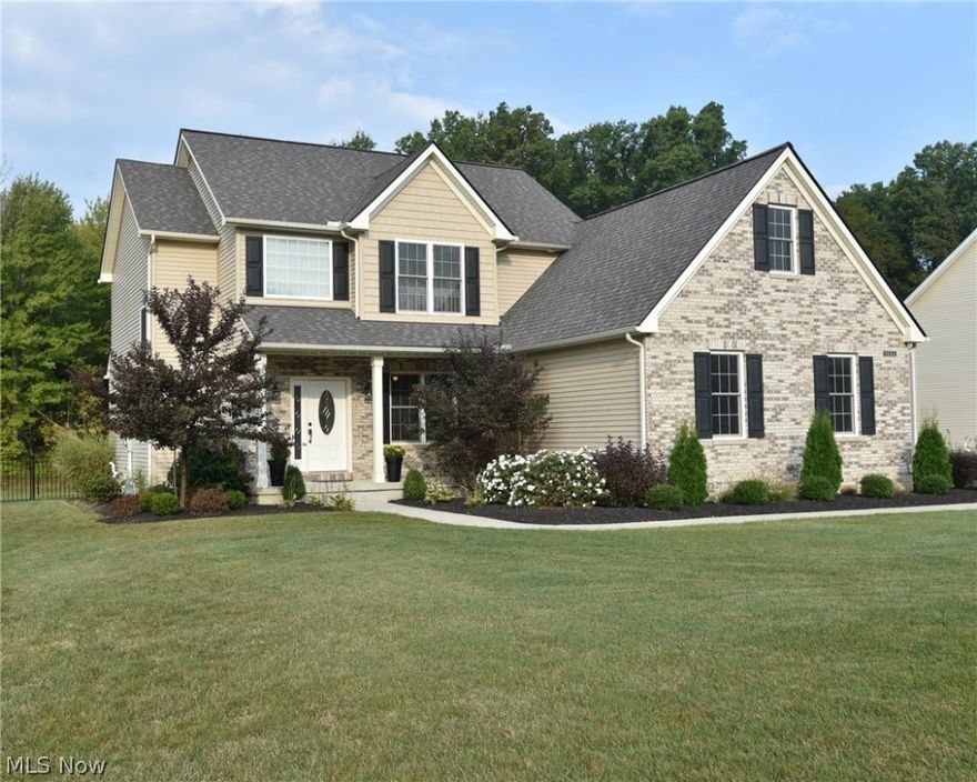 Welcome to this 5 year young, well-maintained colonial in an exquisite neighborhood of fine homes! Upgraded front door; 2-story foyer with coat closet and authentic ceramic tile. Bright and spacious family room, kitchen, and morning/sun room all open to each other allowing for plenty of entertaining space. Family-sized kitchen offers cabinets rich in color topped with crown molding and dovetailed, soft-close drawers; grouted, luxury vinyl tile; center island; GE slate appliances; and 4x4 pantry. Family room has a ceiling fan and large wall for a big screen TV. Sizable 1st floor laundry/mud room with window includes coat rack/cubbies and newer Whirlpool washer/dryer set that remains. Convenient 1st floor half bath off laundry/mud room. Large master suite offers a tray ceiling with fan, separate HIS & HER walk-in closets, private bath with double sinks/vanities, 5' shower and linen closet. Three additional bedrooms, full bath and linen closet complete the 2nd floor. Front porch; large ya