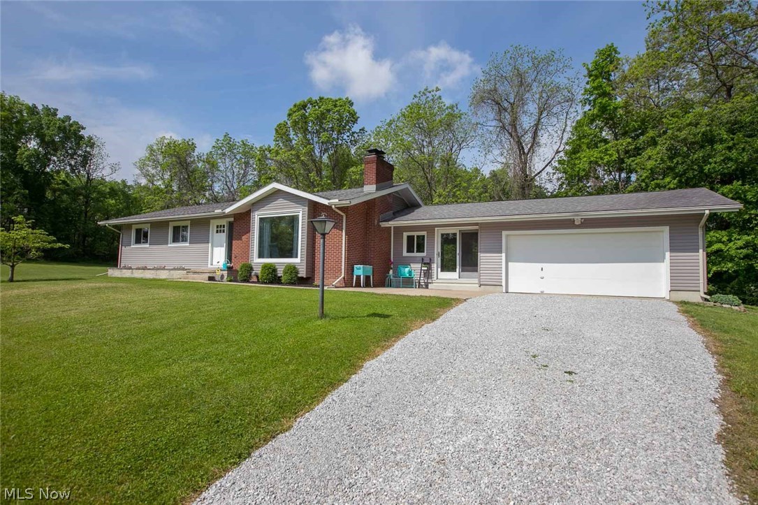 This home is for the nature lover who wants privacy and peace! Every room in it has beautiful views of the outside and tons of natural sunlight shining through. Situated perfectly on 2.88 completely private acres, this home is not even visible from the street! With three bedrooms, one and a half baths, 1274 square feet of above ground living space, and a partially finished basement, this is a rare opportunity for someone looking to upgrade their home and property. There are stainless steel appliances, quartz countertops, a two-car attached garage, a huge mudroom, and 2 lovely gas fireplaces. This is a one owner home, and this is the first time that it is ever going for sale to the public! Large, beautiful pieces of property like this do not come around often in Cuyahoga Falls!