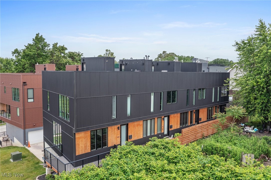 This contemporary townhouse, built in 2021, offers an exclusive opportunity to live in one of Cleveland's most sought-after neighborhoods. Located just steps from the Tremont Towpath, the home features breathtaking views of the Cleveland skyline from all three levels and a rooftop deck with a built-in kitchen, perfect for entertaining. The spacious 2-bedroom, 2.5-bathroom layout boasts high-end finishes, including hardwood floors throughout and tile in the basement. The open floor plan allows for easy living and entertaining, with a kitchen complete with quartz countertops, modern appliances, and plenty of natural light through large windows. The townhouse also includes a finished mudroom in the basement for additional space for storage. Additional features include a 2-car attached garage with access directly from the unit, central air conditioning for year-round comfort, and included appliances like a dishwasher, garbage disposal, washer/dryer, refrigerator, and on the rooftop a built-in gas grill and sink with both hot and cold. Enjoy the best of Cleveland living with proximity to the CLE/Akron Towpath Trail, as well as easy access to downtown Cleveland, restaurants, shops, and bars along Professor Avenue, all within a 5-minute walk.