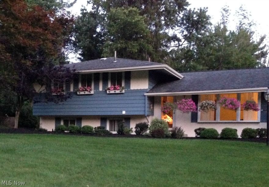 Beautiful, move in ready home. 4 level split has an eat-in kitchen w/granite counters. Spacious living room w/large window. Dining room w/wood floor and door to custom 4-season room heated by a gas fireplace. Large owners suite. Family room w/door to custom deck w/hot tub. Finished lower level w/rec room and private office. Wood floors in 3 bedrooms. Living room has covered wood floors. This is truly a stunning, must see home! Park like setting. All kitchen appliances stay. Home warranty included. Prime location. Award winning school system.