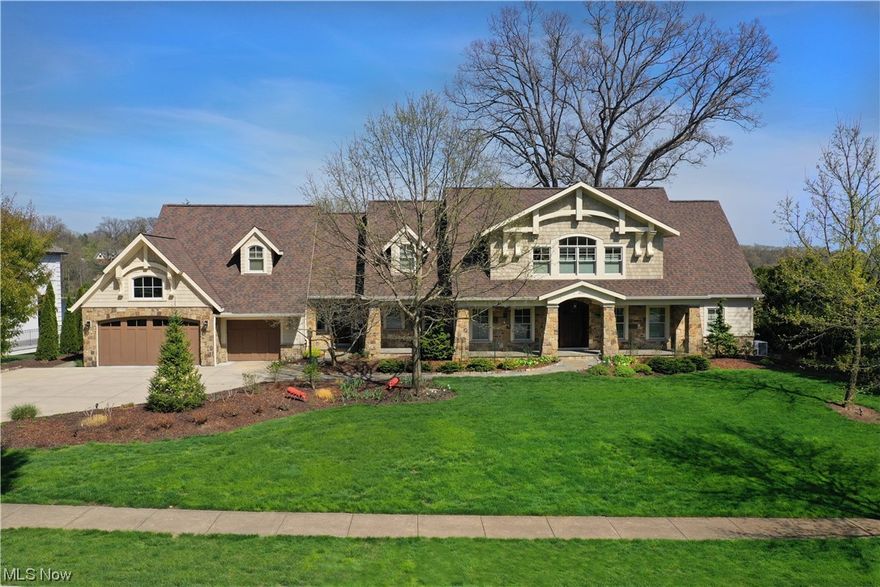 Welcome home to this exquisite Silver Lake Estates lakefront home situated on Silver Lake offering expansive water views from nearly every room. Newly built in '97 then expanded with extensive renovations designed by Peninsula Architects resulting in this magnificent 5200 sq ft home with 5 bedrooms, 5.5 baths, finished basement & 3+ car heated garage. A charming Craftsman style exterior creates an impressive & welcoming curb appeal. The foyer flows into the open concept main living and dining areas where the 2 story floor to ceiling windows provide a backdrop of tranquil lake views. The decor is elegant throughout with rich warm hardwood floors & neutral toned walls. Fabulous eat in kitchen is a cook's joy with Wolf & Sub Zero appliances & Rutt cabinets. There is a first floor Primary bedroom wing, perfect for a first level Primary suite, guest or multigenerational space with a cozy fireplace and french doors that open to the patio and lake. An elegant staircase to the 2nd floor great