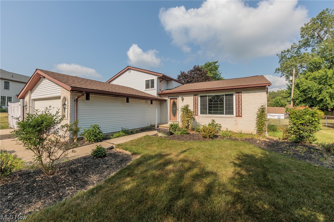 Welcome to this charming split-level home in Strongsville! With its attached two-car garage, 3 bedrooms, and 2 baths, this home has plenty to offer. As you enter, you'll be greeted by the open and airy vaulted living room, featuring new hardwoods installed in 2021. Adjacent to the living room is the formal dining area, creating a seamless flow. The remodeled eat-in kitchen, updated in 2020-21, boasts ample cabinetry, prep space, included appliances, and access to the pergola and stamped patio, perfect for outdoor entertaining. The fully fenced-in backyard provides plenty of space for gatherings with family and friends, and it includes a storage shed for tools. Moving on, the cozy family room awaits on the lower level, complete with an 82% efficient wood-burning fireplace featuring an insert with a blower. A fully updated bath with a barn door and a utility room complete this level. The basement offers additional storage space for your convenience. Upstairs, you'll find three sizable be