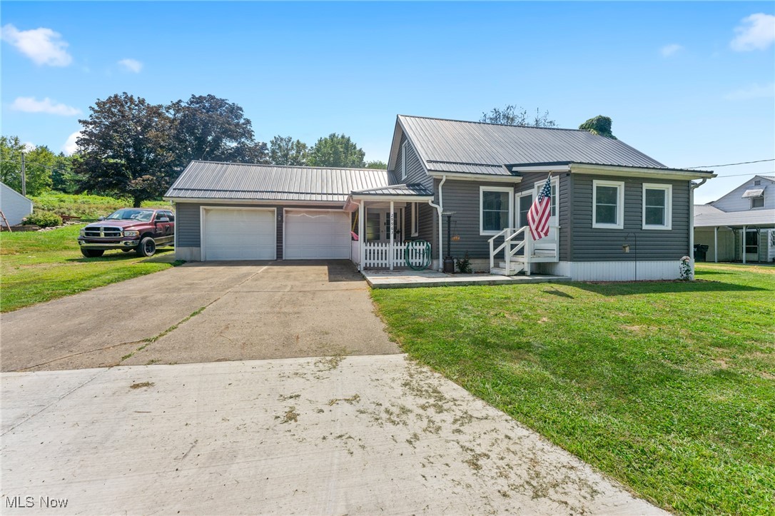 Welcome to this well maintained & updated 3-bedroom, 1.5-bath home that blends classic charm with modern convenience! Nearly everything was updated in 2022, including a gas furnace, refinished hardwood and vinyl flooring, vinyl siding, metal roof, and a newer 100-amp electrical service—making this home move-in ready with peace of mind. The main floor features a convenient layout with one bedroom and a half bath, along with a cozy living room complete with a fireplace, a bright kitchen, dedicated laundry area, and enclosed side and front porches for extra living space or storage. Upstairs, you’ll find two additional bedrooms, a full bathroom, and unique dormer storage nooks that add character and functionality. Outside, enjoy a fenced-in backyard with a patio perfect for relaxing or entertaining. A 2-car garage with brand-new doors adds convenience, and the newly installed public sewer connection is a big plus. Don't miss your chance to own this well-maintained home with thoughtful updates throughout!