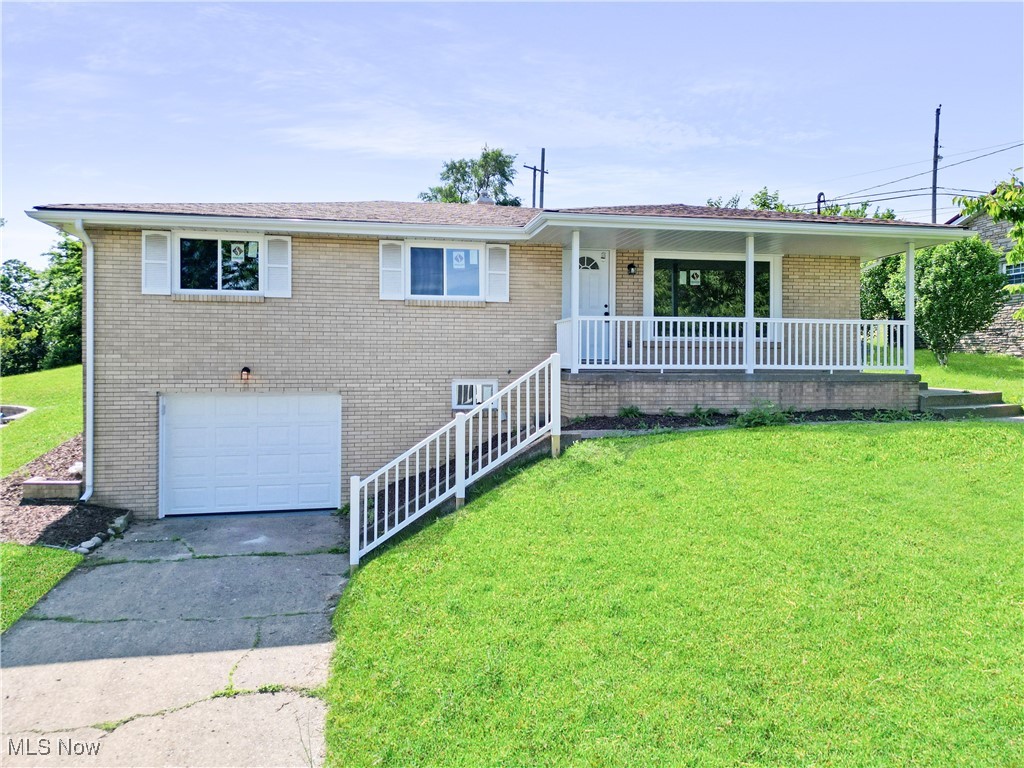 Welcome to this beautifully updated 3-bedroom, 2-bath brick ranch located in a desirable area of Steubenville, Ohio—just minutes from local amenities, shopping, and schools. This move-in-ready home features a brand-new custom kitchen with soft-close cabinetry, granite countertops, and stylish finishes. Both bathrooms have been fully renovated, and the main level offers new luxury vinyl plank flooring with carpet in the hallway and bedrooms. The large, clean, open basement provides excellent storage or the perfect opportunity to add finished living space. Enjoy your morning coffee on the covered front porch or unwind on the back concrete patio, shaded by a retractable awning. Additional updates include a new furnace, central air, windows, soffit, fascia, gutters, all-new exterior doors, and a new garage door. With modern upgrades throughout and a convenient location, this home is ready for you—schedule your private showing today!