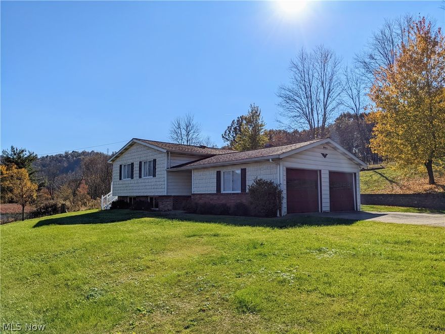 RAYLAND!! CALL TODAY to view this GORGEOUS BI-LEVEL COUNTRY HOME with an attached 2 car garage... IMMACULATE & MOVE IN READY!! 3/4 bedrooms, an AMAZING main bath with a UNIQUE built in sink and lighting, an EAT-IN kitchen with an EAT-AT island hosting BEAUTIFUL cabinetry, a built in oven and microwave plus a cooktop and ceramic tile flooring. The living room and dining room offer original wood flooring. The full finished walk out lower level has lovely laminate flooring and a bonus room or 4th bedroom. This home has GREAT curb appeal, a wonderful country setting and a LARGE ENTERTAINING DECK plus a retaining wall and shed in the back yard. 1839 SF of AWESOME LIVING SPACE!! LOCATED ONLY 3 minutes from Buckeye Local High School. DON'T miss out on this one!