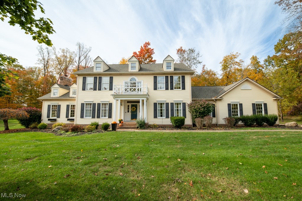 Welcome to this Custom, James A Young designed, Center Hall Colonial in Hudson Park Estates. This unique home offers Tall Ceilings, Hardwood floors and White Crown molding and trim throughout the first floor formal rooms, showcasing excellent craftmanship. The covered entry way brings you to the foyer where you have two coat closets. To the right is a bright living room with built-in bookcases. Through windowed French Doors to the contrasting Den with rich warm wood paneling, closet and gas Fireplace. Left of the Foyer is the gorgeous Dining Room with current wall paper above the Wainscoting and a stunning tray ceiling. The beautifully updated Kitchen has floor to ceiling cabinets, some with glass fronts and granite counter tops with contrasting breakfast bar! Top of the line stainless Steal appliances, including a Kitchenaid convection wall oven, Wolf Stove and Bosch Dishwasher, Under cabinet lighting, pendant lighting, appliance garage and stunning ceramic tile backsplash. Beautiful glass doors from eat-in area to the new Trex deck and brick patio. Vaulted ceilings with actual dormers, a Bay window and windows with arch tops bring abundant light to the Family Room. The Brick Chimney to the ceiling with wood mantel makes this wood burning Fireplace the focal point of the room. Back Hall has an Updated Full Bath with In-Law Suite Possibilities. Plus the Laundry Room with Window, large pantry closet and new sink and a lovely Mud Room with coat closets and door to the 3 car garage. Upstairs there is a lovely wide Hallway with a Hall Bath that opens to one bedroom and the hall for two more bedrooms  The Primary Bedroom has a vaulted ceiling, large Bathroom and Walk-in Closet! In the Lower Level there is a Recreation area, Large Shop area, rough-in for Bathroom, an office/studio and plenty of storage. Hudson Park Estates is a popular Swim and Tennis neighborhood with lessons, fishing and Social Events. Close to Hudson City Schools and new sidewalks to downtown Hudson!