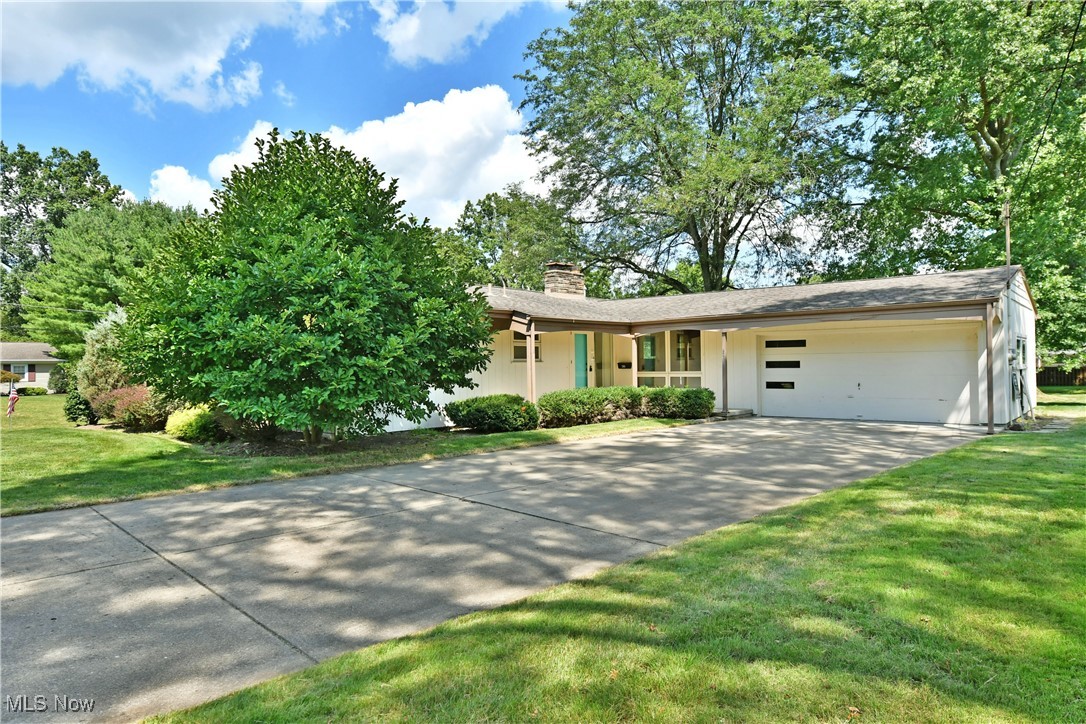 Here's your chance to put your personal style into a unique mid century modern style home in the heart of Canfield! This sprawling ranch is within walking distance to schools and swim club! The open concept main living area has vaulted and beamed ceilings with a fireplace and floor to ceiling windows that really bring the wow factor! There is believed to be hardwood floors under great room and hallway carpets. A bright and airy galley style kitchen with dining area are just off the main living area. Additionally, there is a family room for more entertaining space with charming built ins. 3 sizeable bedrooms with original hardwood floors and large closets. The bathrooms have all of the well cared for, original tile. Master bedroom has an en suite bath. Large finishable basement with a wood burning fireplace, plenty of room for storage and a half bath. 2 car attached garage, concrete driveway and large back patio overlooking backyard are just a few more of the many things to love about this home. Whether you want to preserve this homes original mid century mod character or bring it into 2024, this home is the right move!