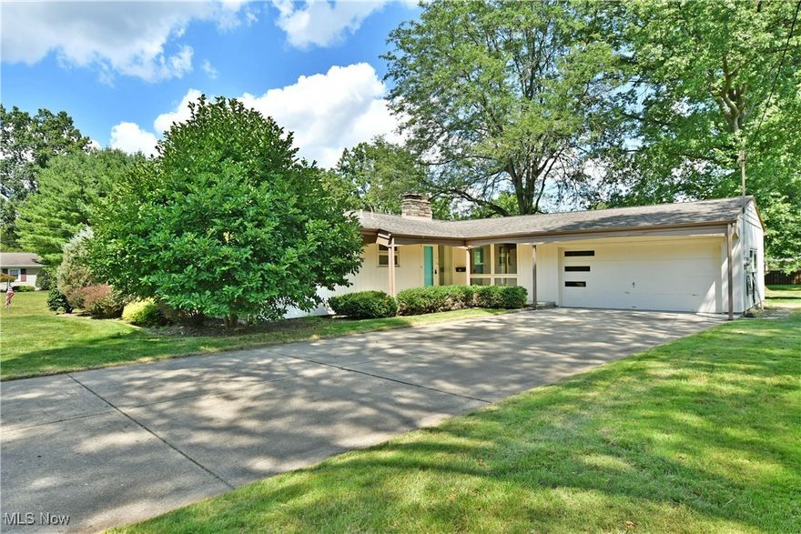 Here's your chance to put your personal style into a unique mid century modern style home in the heart of Canfield! This sprawling ranch is within walking distance to schools and swim club! The open concept main living area has vaulted and beamed ceilings with a fireplace and floor to ceiling windows  that really bring the wow factor! There is believed to be hardwood floors under great room and hallway carpets. A bright and airy galley style kitchen with dining area are just off the main living area. Additionally, there is a family room for more entertaining space with charming built ins. 3 sizeable bedrooms with original hardwood floors and large closets. The bathrooms have all of the well cared for, original tile. Master bedroom has an en suite bath. Large finishable basement with a wood burning fireplace, plenty of room for storage and a half bath. 2 car attached garage, concrete driveway and large back patio overlooking backyard are just a few more of the many things to love about this home. Whether you want to preserve this homes original mid century mod character or bring it into 2024, this home is the right move!