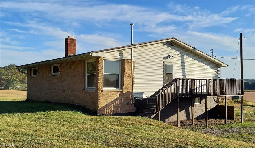 Pack your things and move right in to this 3-bedroom brick Ranch that sits on 1.534 acres of country! New drywall, fresh paint and all new windows throughout. The main level has new vinyl flooring in kitchen, laundry and full bath. Beautiful original hardwood floors in living room, bedrooms and spacious hallway. Outside you can enjoy the 8x14 foot deck or go around to the back patio. The basement has it's own outside entrance. At one time it was a separate living space and still has kitchen, recreation room with fireplace, laundry, plumbed for full bathroom and has space that could be bedrooms again, with some renovation. Large, open yard with a barn on the edge of property. Heated with free gas, as long as the well produces. Cash or conventional only. Call today to arrange a personal viewing!