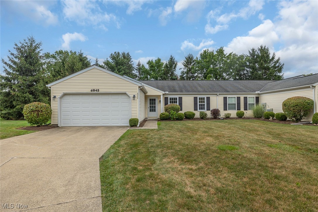 Nestled at the end of a serene cul-de-sac in the Farmington Meadows development, this beautifully updated 3-bedroom, 2-bath Mentor condo combines comfort, style, and convenience. Newer luxury vinyl plank wood flooring spans the main areas and is complemented by plush carpeting in the bedrooms. New modern ceiling fixtures, including fans, enhance the fresh ambiance throughout. The spacious living room with vaulted ceilings sets a welcoming tone, flowing seamlessly into the adjacent eat-in kitchen. Recently updated kitchen features include a new faucet, stove/oven, and refrigerator. Sliding doors from the dining area lead to a generous deck, surrounded by privacy fencing and overlooking a large backyard bordered by trees and an open field—an ideal space for both relaxation and entertaining. Additional highlights include a sizable laundry and utility room with ample storage alongside a convenient two-car garage. Situated near Edward R. Walsh Park, this move-in ready home offers easy access to freeways, restaurants, gas stations, grocery stores, and local businesses, ensuring effortless everyday living. Schedule your showing today!