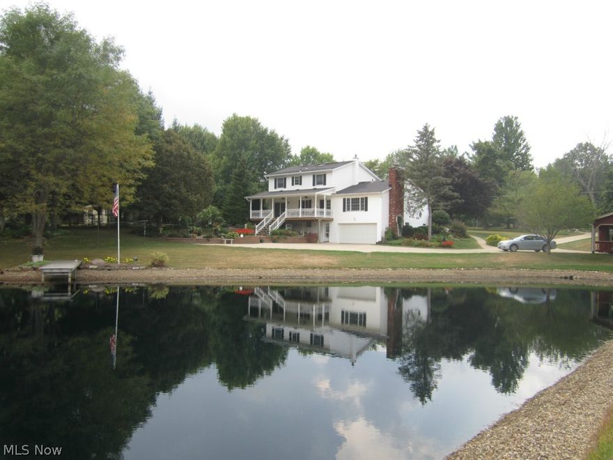 Beautiful lake and landscaping with this almost 6 acre property. Enjoy your morning coffee on the covered front porch and the breathtaking view from the covered back porch. Kitchen and dining room French doors open to back porch. Newer Jenn-air in kitchen Island. First floor bedroom with full bath or choose second floor bedroom with full bath as the Master suite. Two-2.97 acre parcels. House with lake and 2.97 acres could be bought for $254,500.00. Additional two car garage with loft and storage area. Large concrete drive for extra parking.Finished Rec. room in walk out basement  with two car garage. Windows in home have glass with UV sun protection. Septic and well have already been inspected. Immaculate roomy home you won't want to miss.