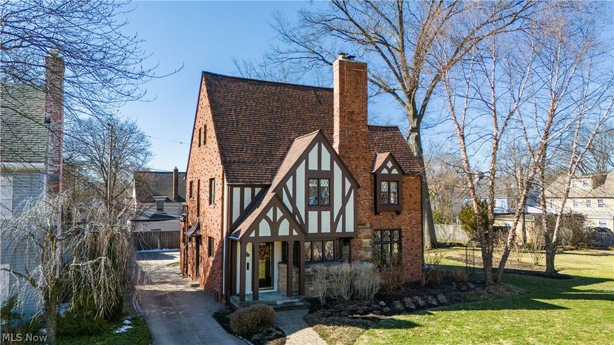 An extraordinary find in Sussex in Shaker Heights that is simply marvelous inside & out! Meticulously restored, maintained & thoughtfully improved by the current owners for their 34 years of stewardship, this architecturally rich Tudor blends irreplaceable craftsmanship with meaningful modern updates. Original arched oak doors, leaded & stained glass windows, carved fireplace mantel, decorative plaster crown molding & built-in china cabinets preserve the home’s historic integrity. The updated kitchen features granite countertops, stainless Frigidaire Gallery appliances, Kraftmaid cabinetry & a separate breakfast nook and pantry. Heated floors in all bathrooms elevate daily living. Upstairs, three bedrooms include a dramatic owner's suite with beamed ceilings & coveted walk-in-closet & feature all new carpeting (2025), a spectacular remodeled full bath with custom tile, granite counters, heated floors & body shower options. The finished third floor offers a private suite with heated bath, new carpeting & its own air handling system — ideal for guests, office or retreat space. Outdoor living is equally exceptional with a large paver patio, separate fire pit area, natural gas grill hookup, Amish-built fencing, professionally designed landscaping &  seasonal water feature. Major improvements include complete roof tear-off (2018), chimney tuckpointing & crown replacement, updated storm & sanitary clean-outs w/ transferable guarantees, copper plumbing, epoxy garage & basement floors, attic insulation & flooring, updated electrical panel, & so much more — totaling approximately $110,500 in upgrades. The 2 car garage has been finished inside in cedar wood creating a fantastic fun, bonus space. Close to RTA & the popular Van Aken District for shopping, restaurants & Market Hall & short drive to University Circle, downtown, hospitals & everything that makes Cleveland Rock! An extremely rare opportunity to own a true piece of classic Shaker Heights architectural excellence!
