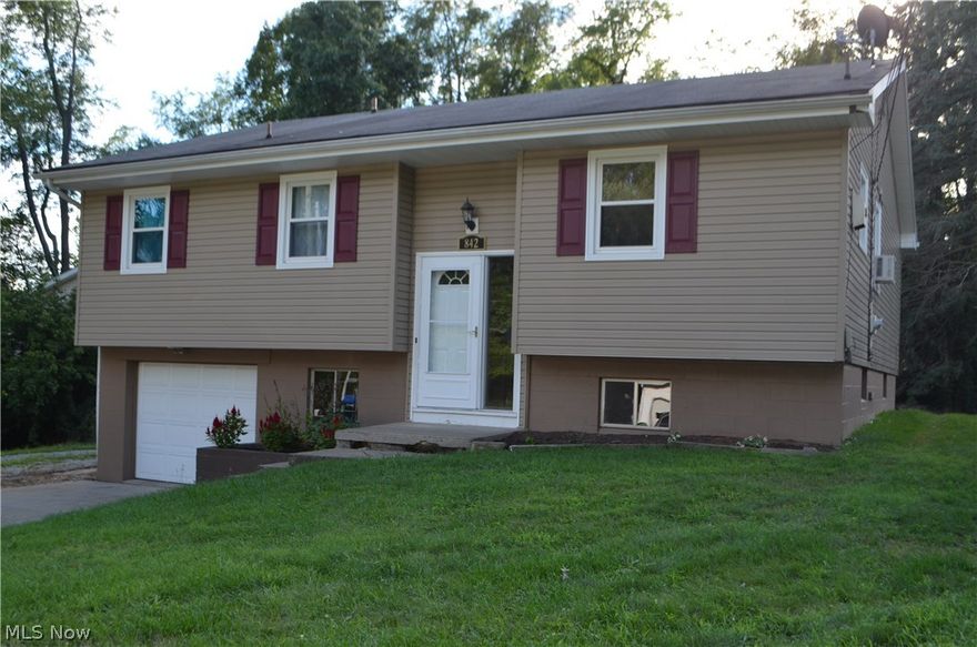 This comfortable home features an open floor plan, 3 bedrooms on the main floor, and a new kitchen. Custom, solid wood cabinets, stainless appliances and new floor. The large living room walks out to a wood deck and semi private back yard. Lower level features new flooring, a large family room, office, and laundry area.