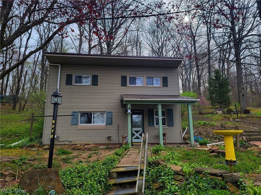 Lake Life ready! Escape to one of Ohio’s premium Muskie fishing lakes when you come to this 2 bedroom, 1 bath home at Leesville Lake. Surrounded in a wooded setting, this home could make a perfect weekend getaway or full-time living.   There is a picturesque gazebo, fire pit area, and detached garage with plenty of space for a workshop or to store all your lake toys. All of this on 5 parcels is just over 1 acre of land. Call today, and come see what all this home has to offer at Leesville Lake.