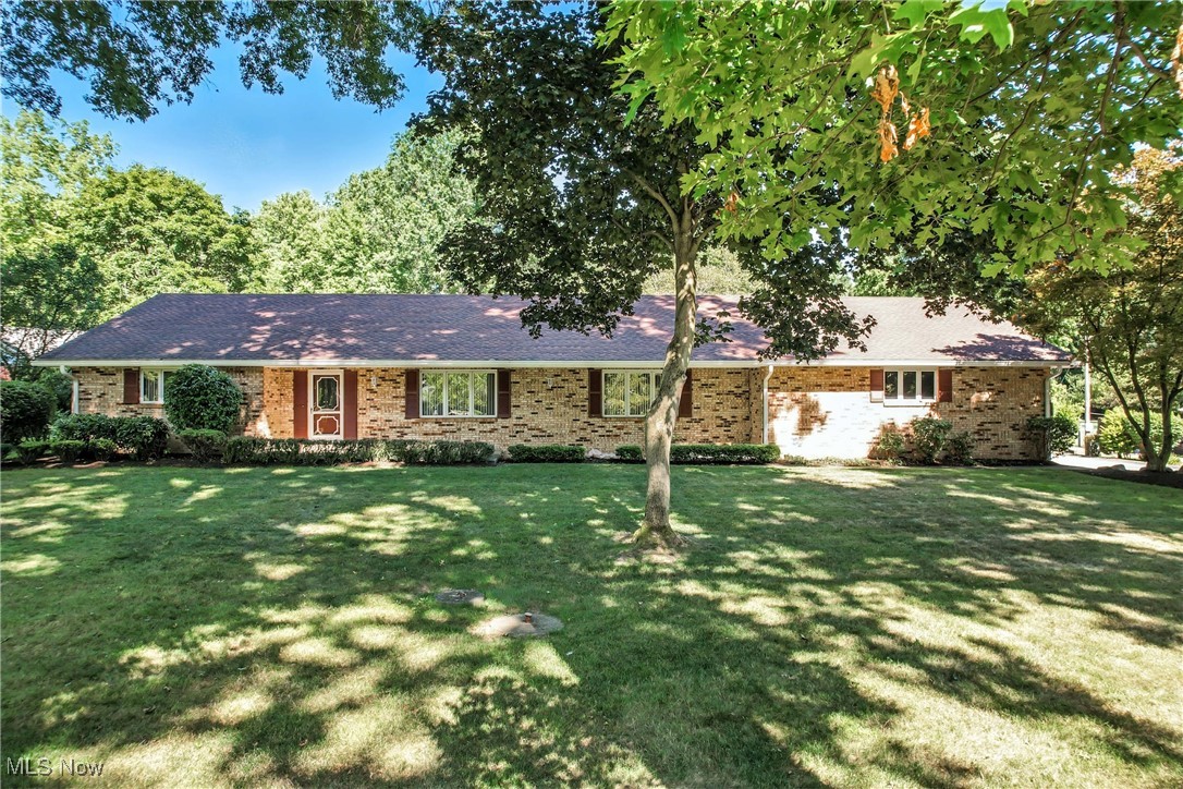 This spacious and thoughtfully designed 3-bedroom, 3-bath brick ranch offers 2,028 square feet of main-level living on a private 140’x307’ lot. Built in 1974 and exceptionally maintained, this home features a functional floor plan, multiple living spaces, and a large basement — ideal for anyone seeking comfort, versatility, and room to grow. Step into the welcoming tile foyer, which opens into a bright and spacious living room. Adjacent is a formal dining room and an eat-in kitchen with abundant cabinetry, tile floors, and all major appliances included: refrigerator, microwave, range, dishwasher, garbage disposal, and more. A cozy family room with a gas log fireplace provides a perfect spot to gather and unwind. The home includes three generously sized bedrooms, all on the main level, with the primary suite offering a private full bath. Two additional full bathrooms accommodate guests and family with ease. The convenient laundry room is also on the main level and includes washer and dryer. One of the home’s standout features is the bright three-season sunroom with tile flooring — a perfect space to enjoy year-round natural light and serene views of the deep backyard. The basement adds incredible flexibility with a recreation room, a workshop, and a cold storage area. The basement includes a partial crawl space and sump pump for added utility and peace of mind. The exterior boasts a welcoming front porch, and a durable brick construction with an asphalt/fiberglass roof. The oversized 3-car attached garage includes electric, water, and a garage door opener — ideal for vehicles, tools, and storage. There is also a large 15’x15’ back garage to store more tools and toys. Whether you're looking for single-level living, workshop space, or room to expand, this move-in-ready ranch offers the perfect blend of functionality and privacy. Schedule your private tour today and explore all the possibilities this well-cared-for home has to offer!