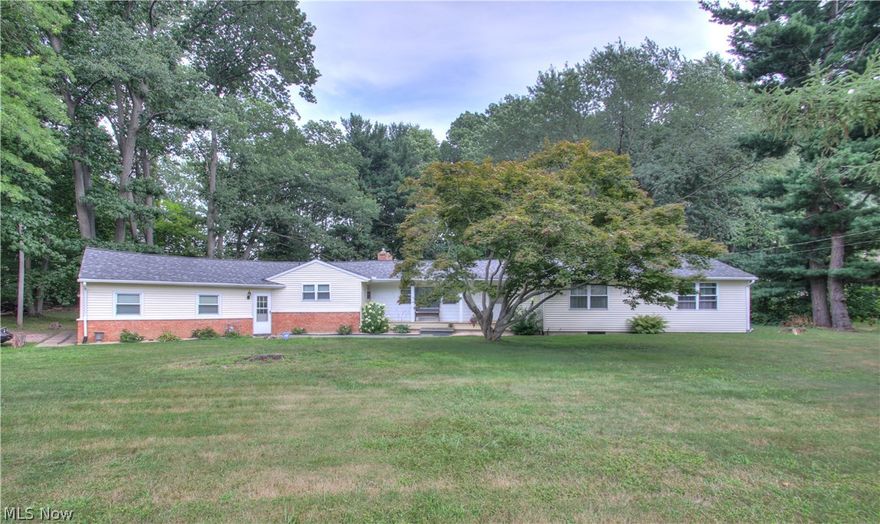 Sprawling ranch home on a beautifully treed lot. Large living room with vaulted wood ceilings and a beautiful brick floor to ceiling fireplace. Nice eat in kitchen with a french door that leads out to the back yard.  The breezeway between the garage and kitchen is full of storage cabinets. The basement has been waterproofed and has newer furnace & breaker panel. Updates include flooring, roof, hi efficiency gas furnace, garage door, 100 amp electric panel and wiring. Make your appt today!
