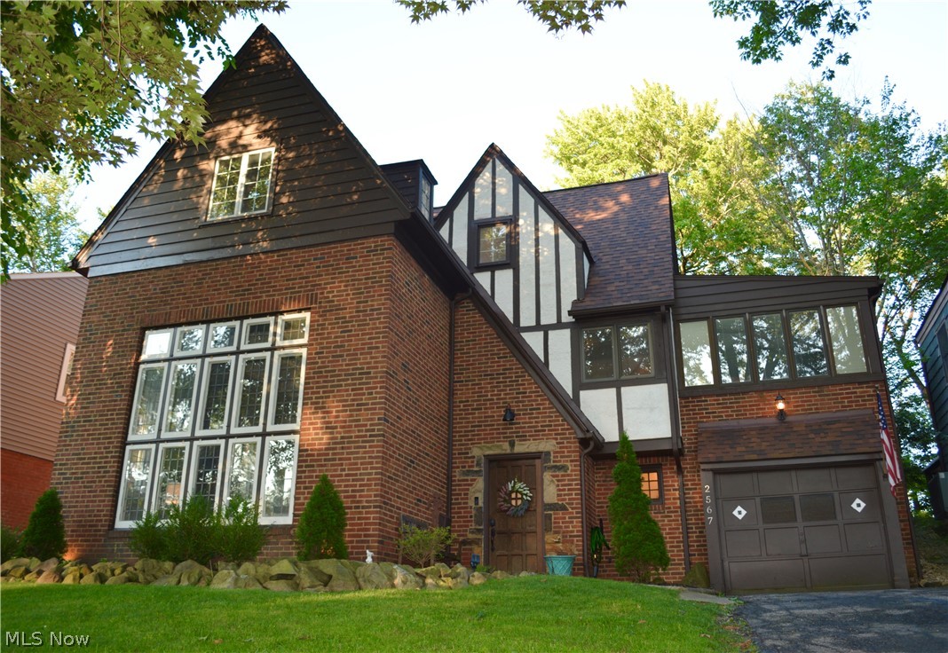 Must See, Beautiful University Heights Tudor! Large, immaculate, well maintained home with huge backyard and CENTRAL AIR!! Perfectly updated with so much of the original character this home is entitled to. You'll be amazed by the wall of windows and grand 2-story ceiling in the great room with gas fireplace. Half bath, garage entry, partial basement/utility room, and large coat closet round out the first floor. Walk up the gorgeous staircase with original iron balusters to the second floor loft. Beautifully remodeled kitchen with nook. Dining room with gorgeous ceiling character and doors to the deck. The third floor hosts the large master bedroom with ensuite bathroom and 2nd extra large bedroom. Before leaving, make sure to take a walk around the backyard. Bocce ball court, large deck, bar, and firepit are all staying!! Lots of green space for entertaining, relaxing, pets, and gardening. Close to shopping, hospitals, schools, and parks. Point of sale is completed and home is complian