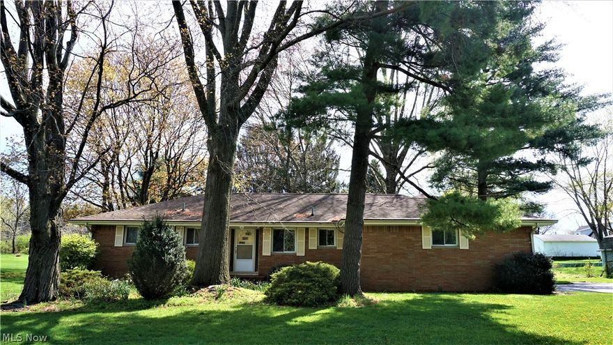 Excellent opportunity in the Lake School District! Brick ranch conveniently located near schools, shopping and highways in a quiet neighborhood in Uniontown. Large eat-in kitchen with newer Range and Dishwasher, laminate counters and tile backsplash. Spacious Family Room includes views of the backyard through a sizable picture window, wood burning fireplace with stone surround and concrete hearth, built-in shelving and ceiling fan. 3-seasons room encased with wall of windows has access to a wooden deck and pergola in the backyard. 2 oversized bedrooms both have loads of closet space and hardwood floors. Full bath with single vanity, oversized counter, attractively tiled walls and ceramic tile flooring. Partially finished basement sports 2 living areas. Large carpeted recreation room with brick fireplace, built-in shelves, and multiple glass block windows providing plenty of natural light. Second living space can serve as an office or a 3rd bedroom which is supported by the 2nd full bat