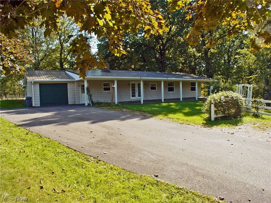 You've arrived! As soon as you arrive driving up this tree lined, paved driveway you will feel the tranquil setting of this pristine country retreat when the country roads take you home to this wonderful property. Completed updated home situated on 7 acres with a 12 stall horse barn, 50x50 indoor arena and a fenced pasture. The home features a beautiful custom  equipped kitchen with hickory cabinetry, heated floors, and beamed ceiling. Hardwood flooring in the living room with fireplace and formal dining, huge first floor laundry/craft room with tons of white cabinetry, heated floors and front-load washer & dryer. Finished basement with wood stove, large family room, kitchenette and bath. So many amenities to the property call for details and yur private showing. Home Warranty included!