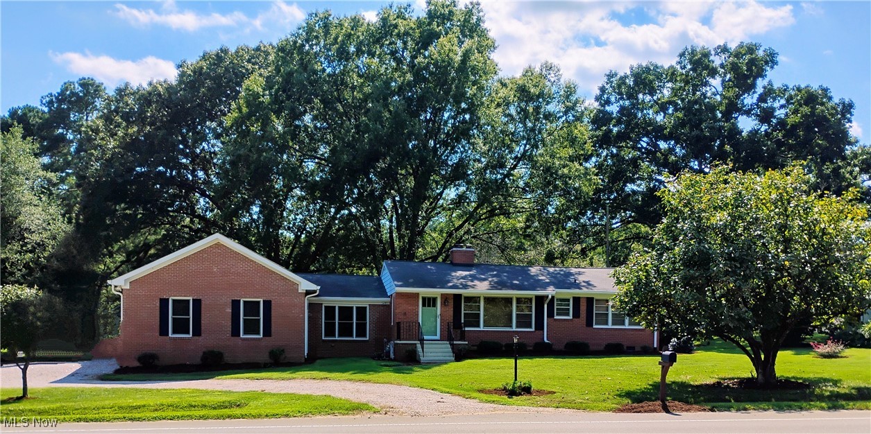 Come and see this beautiful, comfortable and country style home in the city of Independence with so much to offer. This house has a newly upgraded modern kitchen on the main level with new cabinets, granite counter tops, breakfast eating peninsula, island work top, refrigerator, electric stove/oven, hood, under-counter microwave set-up, disposal and dishwasher (all appliances less than 5 yrs. old). First floor has newly refinished solid oak wood floors, (1) spacious bedroom and (1) full bath (separate shower and tub). The upper level has (3) bedrooms ((1) @ 9' x 12' with built-in desk/drawers, (1) @10' x 13' with a closet and (1) @13' x 21' with built in drawers and a closet) (1) half bath and a large walk-in closet/storage area. The basement is unfinished and has (1) full bath with a shower, a canning room, large laundry area, work/utility room and an area for a future entertainment room. There is a 120/220V electrical service located in the garage. The home utilities are public sewers, city water, 100A electrical service and natural gas. The hot water heater is 9 yrs old. The home is heated by a forced air furnace which is 20+ yrs old. This home features a fully covered front porch and an enclosed cozy sun-room at the rear entry. The house is situated on a 0.84 acre lot (83' w. x 441' deep) that is surrounded by seasonal landscaping and plantings. There is a circular concrete entertainment patio with privacy fencing and mature trees that provide refreshing shade during the hot summers just south of the rear entry. There is a gas hook-up available for a gas grill. The rear yard has a large flat grassy area with mature trees and plantings that provide privacy from the neighbors and also shading for family functions. The southern portion of the lot slope down to a stream and extends +/-12' past the stream and has numerous full growth trees for privacy. The driveway is a 5 yr old concrete drive with a large turn around that ends at a masonry (2) car detached garage.